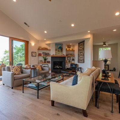 Living room - large 1960s open concept light wood floor, brown floor and vaulted ceiling living room idea in Other with white walls, a standard fireplace and a tile fireplace
