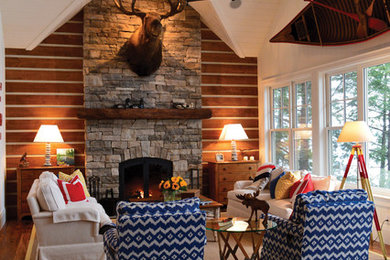 Inspiration for a rustic living room remodel in Toronto with a standard fireplace and a stone fireplace