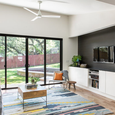 Inspiration for a small contemporary open concept and formal light wood floor and beige floor living room remodel in Austin with a wall-mounted tv and white walls