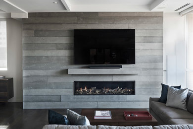 トロントにある高級な中くらいなコンテンポラリースタイルのおしゃれなLDK (白い壁、濃色無垢フローリング、標準型暖炉、コンクリートの暖炉まわり、据え置き型テレビ、茶色い床) の写真