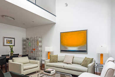 Trendy open concept medium tone wood floor living room photo in New York with white walls