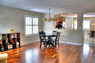 Large formal and open concept dark wood floor living room photo in Albuquerque with beige walls, no fireplace and no tv
