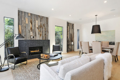 Example of a transitional open concept medium tone wood floor living room design in San Francisco with white walls, a standard fireplace and a tile fireplace