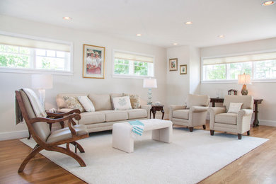 Example of a large transitional formal and open concept light wood floor living room design in Boston with white walls
