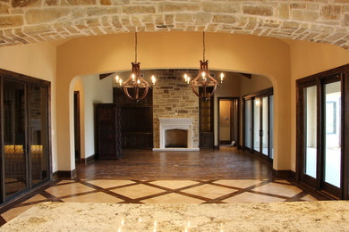 Imagen de salón mediterráneo extra grande con paredes beige, todas las chimeneas y marco de chimenea de piedra