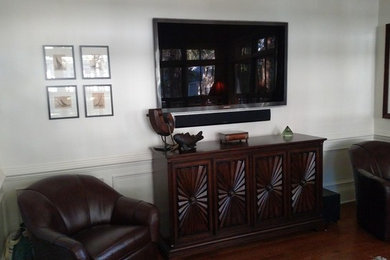 Mid-sized elegant formal and enclosed dark wood floor and brown floor living room photo in Atlanta with white walls, no fireplace and a wall-mounted tv