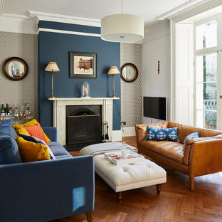 Design ideas for a victorian formal living room in London with multi-coloured walls, medium hardwood flooring, a standard fireplace and brown floors.