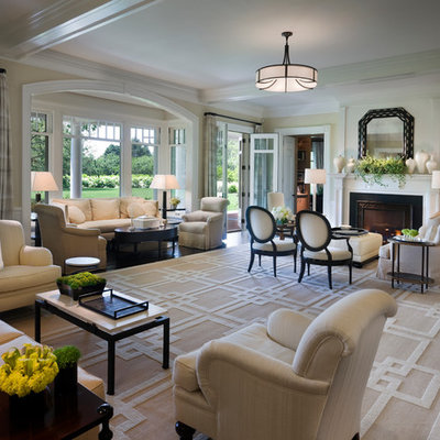 Example of a huge ornate living room design in New York with beige walls and a standard fireplace