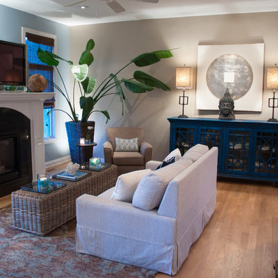 Living room - coastal open concept medium tone wood floor living room idea in Other with beige walls and a standard fireplace