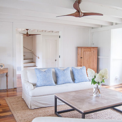 Large beach style formal and open concept medium tone wood floor living room photo in Other with white walls, no tv, a standard fireplace and a brick fireplace