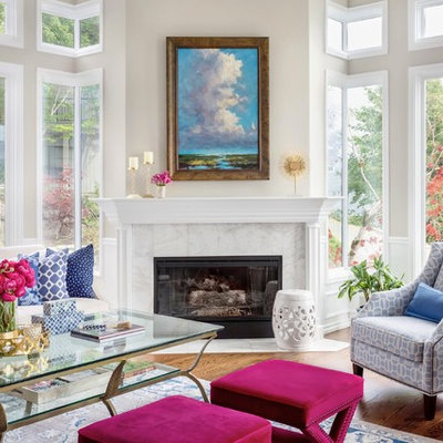 Example of a large classic open concept medium tone wood floor and brown floor living room design with gray walls, a standard fireplace, a stone fireplace and no tv