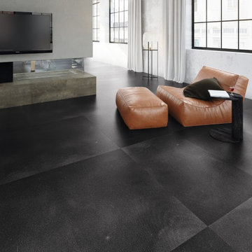 Spacious living room with black concrete tile flooring