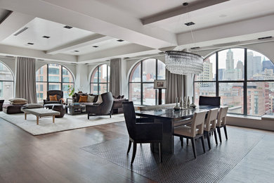 Huge trendy open concept dark wood floor living room photo in New York