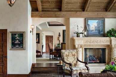 Living room - large mediterranean formal and open concept terra-cotta tile and brown floor living room idea in San Diego with beige walls, a stone fireplace, no tv and a standard fireplace