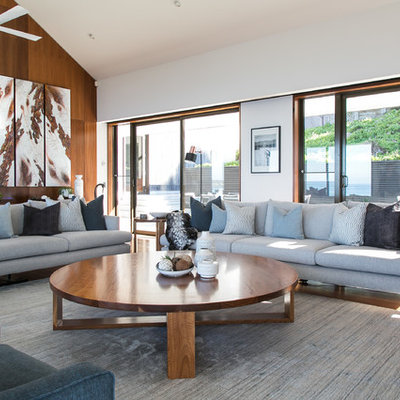 Example of a large trendy formal and open concept brown floor and dark wood floor living room design in Melbourne with white walls
