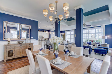 Elegant medium tone wood floor, brown floor, coffered ceiling and wall paneling dining room photo in Philadelphia with blue walls