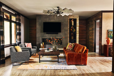 他の地域にある高級な広いコンテンポラリースタイルのおしゃれなLDK (磁器タイルの床、標準型暖炉、タイルの暖炉まわり、壁掛け型テレビ、ベージュの床) の写真