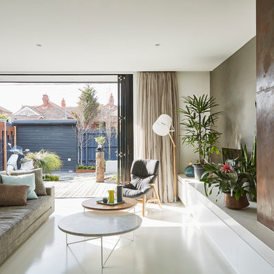 Inspiration for a mid-sized contemporary open concept concrete floor living room remodel in Melbourne with a standard fireplace, a metal fireplace and gray walls