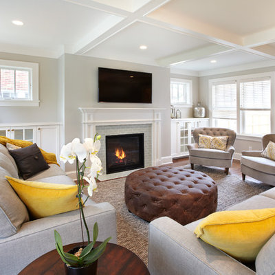 Living room - mid-sized transitional enclosed medium tone wood floor living room idea in Minneapolis with gray walls, a standard fireplace, a tile fireplace and a wall-mounted tv