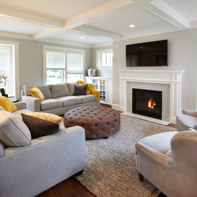 Living room - mid-sized transitional enclosed medium tone wood floor living room idea in Minneapolis with gray walls, a standard fireplace, a tile fireplace and a wall-mounted tv