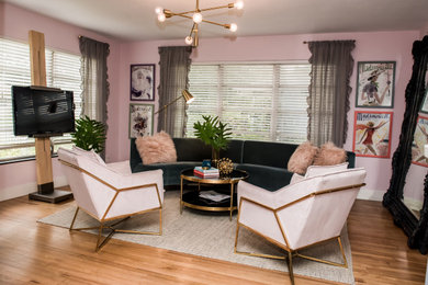 Mid-sized 1950s open concept light wood floor and multicolored floor living room photo in Tampa with pink walls and a tv stand