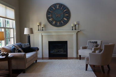 Example of a transitional medium tone wood floor living room design in Columbus with beige walls