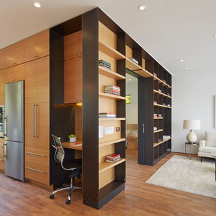 Small trendy open concept medium tone wood floor living room library photo in San Francisco with white walls