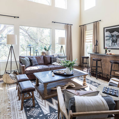 Living room - large rustic dark wood floor and brown floor living room idea in Sacramento with a bar, beige walls and no tv