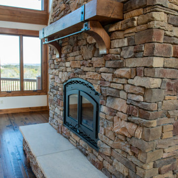 Stone Fireplace with wood burning stove, recaimed mantle