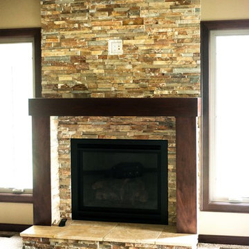 Stone fireplace with wood mantel shelf