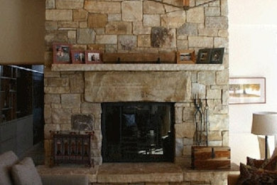 This is an example of a contemporary living room in Burlington with beige walls, a two-sided fireplace and a stone fireplace surround.