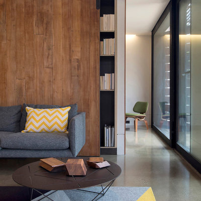 Living room library - contemporary open concept concrete floor living room library idea in Melbourne with white walls