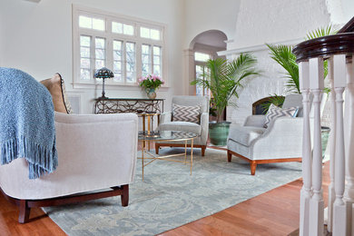 Example of a small light wood floor living room design in Wilmington with white walls and no tv