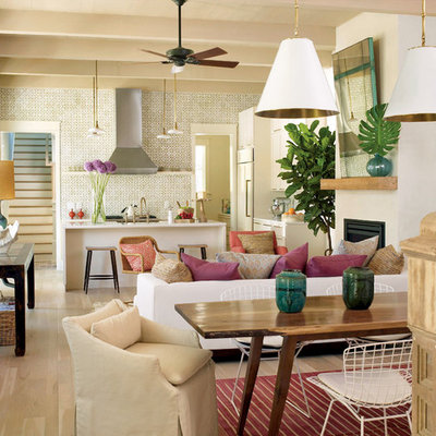Inspiration for a tropical living room remodel in Charleston with white walls and a standard fireplace