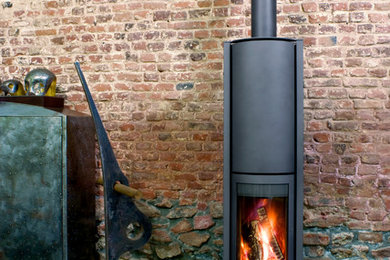 Design ideas for a contemporary living room in Gloucestershire with a wood burning stove.
