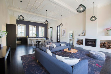 This is an example of a large contemporary living room in Melbourne with grey walls, dark hardwood flooring and brown floors.