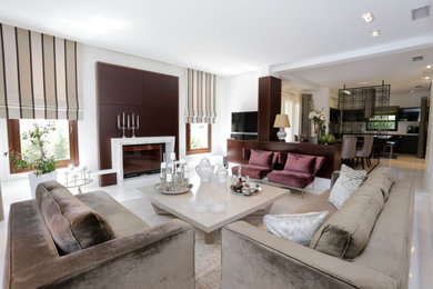 Inspiration for a large eclectic living room in Surrey with white walls, marble flooring, a standard fireplace, a stone fireplace surround, a wall mounted tv and white floors.