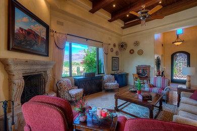 Example of a large southwest open concept travertine floor living room design in Phoenix with beige walls, a corner fireplace, a stone fireplace and a concealed tv