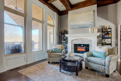 Example of a large transitional open concept medium tone wood floor living room design in Kansas City with gray walls, a standard fireplace and a stone fireplace