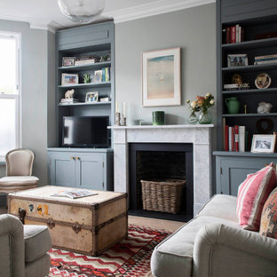 This is an example of a classic enclosed living room in London with grey walls, medium hardwood flooring and brown floors.