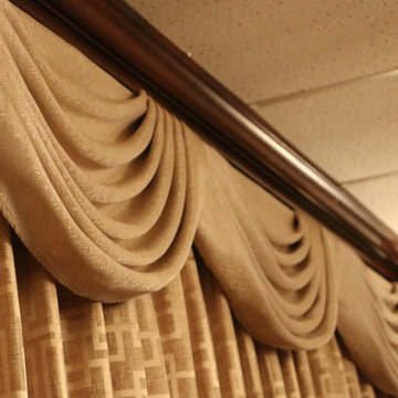 Swags overlaying pinch pleated curtains