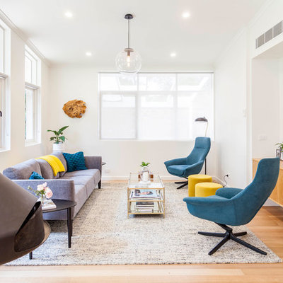 Living room - 1960s open concept light wood floor living room idea in Melbourne with white walls, a hanging fireplace and a metal fireplace