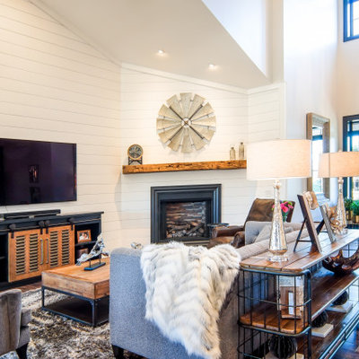 Inspiration for a country medium tone wood floor living room remodel in Cleveland with white walls
