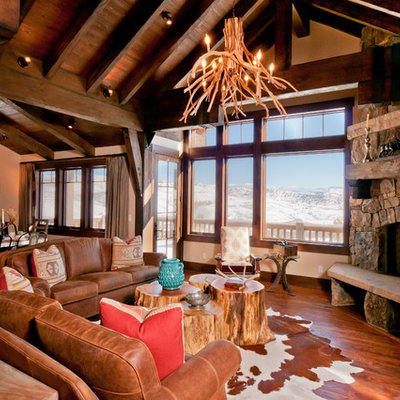 Mid-sized mountain style open concept and formal medium tone wood floor living room photo in Denver with beige walls, a corner fireplace, a stone fireplace and a concealed tv