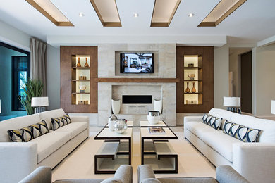 Living room - large contemporary open concept limestone floor and beige floor living room idea in Miami with beige walls, a wall-mounted tv, a ribbon fireplace and a stone fireplace