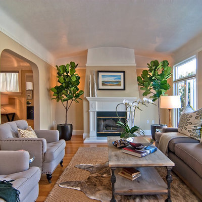 Living room - contemporary enclosed living room idea in San Francisco with beige walls and a standard fireplace
