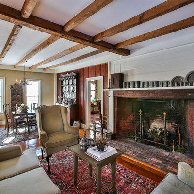 Inspiration for a farmhouse formal and open concept medium tone wood floor living room remodel in Boston with beige walls, a standard fireplace, a brick fireplace and no tv