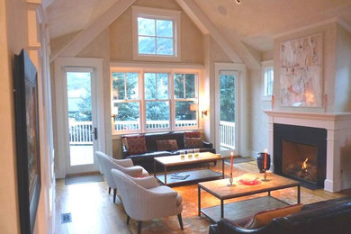 Example of a mid-sized transitional open concept light wood floor and brown floor living room design in Denver with beige walls and a standard fireplace