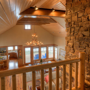 Inspiration for a mid-sized country loft-style carpeted and beige floor living room remodel in Seattle with beige walls, a standard fireplace and a stone fireplace