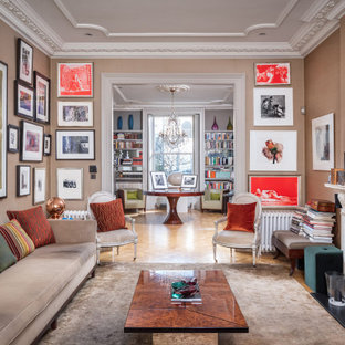 Inspiration for a large bohemian formal open plan living room in London with blue walls and medium hardwood flooring.